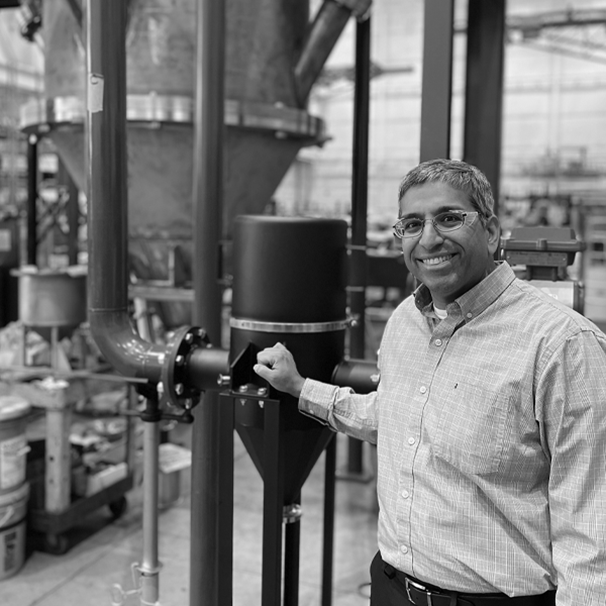 Company page image with man standing at pipes